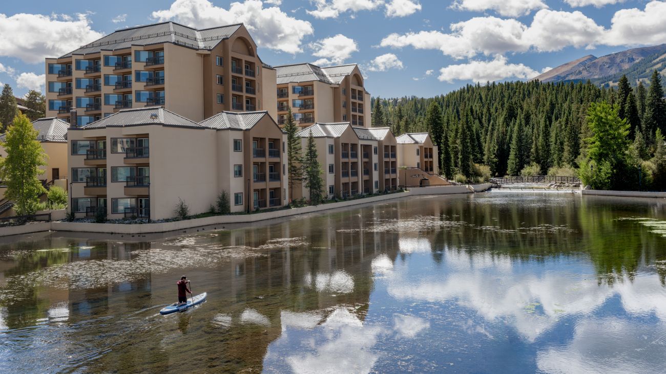 Aerial view of lake at Marriott's Mountain Valley Lodge timeshare location showing snow-capped mountains in background